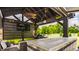 Well-appointed outdoor kitchen with a grill, TV, bar seating, and a scenic view at 15920 Oak Park Ct, Westfield, IN 46074