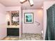 Charming pink bathroom featuring unique vanity mirror, tiled floor, and a window for natural light at 1624 Riley Rd, Lebanon, IN 46052