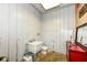 Functional bathroom featuring simple vanity, toilet, and corrugated metal walls, offering practicality and ease of maintenance at 1624 Riley Rd, Lebanon, IN 46052