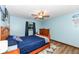 Serene bedroom with wood flooring, a ceiling fan, and a large window with natural light at 1624 Riley Rd, Lebanon, IN 46052