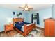 Bright bedroom with a ceiling fan, wood flooring, and a dresser for storage at 1624 Riley Rd, Lebanon, IN 46052