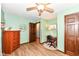Comfortable bedroom with wood floors, ceiling fan, with a decorative dresser and a unique layout at 1624 Riley Rd, Lebanon, IN 46052