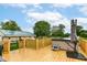 Outdoor deck featuring a hot tub, patio umbrella, and green yard with blue sky overhead at 1624 Riley Rd, Lebanon, IN 46052