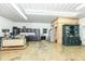 Bright garage space with concrete flooring, featuring an organized workspace and convenient access to a restroom at 1624 Riley Rd, Lebanon, IN 46052