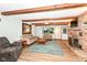Inviting living room with exposed wood beams, brick fireplace, and stylish decor at 1624 Riley Rd, Lebanon, IN 46052