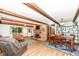 Bright living area featuring brick fireplace, wood beams, and adjacent dining space at 1624 Riley Rd, Lebanon, IN 46052