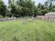 Large, grassy backyard featuring swing, sitting bench, firepit and wood fence at 1816 Hemlock Ln, Plainfield, IN 46168