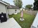 Home featuring a grassy yard, deck with grill, and privacy fence at 1816 Hemlock Ln, Plainfield, IN 46168