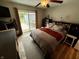 Comfortable bedroom features a queen bed, outdoor access, wood floors, and neutral paint at 1816 Hemlock Ln, Plainfield, IN 46168