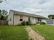 Charming single-story home with a brick and siding facade and a well-manicured lawn on a cloudy day at 1816 Hemlock Ln, Plainfield, IN 46168