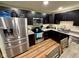 Bright kitchen with stainless steel appliances, ample dark cabinet space, and modern countertops at 1816 Hemlock Ln, Plainfield, IN 46168