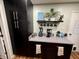 A well-organized kitchen area with a built-in coffee station, ample countertop space, and dark cabinets for storage at 1816 Hemlock Ln, Plainfield, IN 46168
