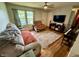 A cozy living room featuring a comfortable sectional, a large window, and a ceiling fan for added comfort at 1816 Hemlock Ln, Plainfield, IN 46168