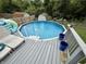 Backyard with above ground pool, deck, lounge chairs, and privacy fence at 1816 Hemlock Ln, Plainfield, IN 46168