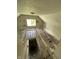 A look down into a room from a stairwell featuring hardwood flooring and a window at 1902 Orange St, Indianapolis, IN 46203