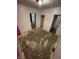 A room with a view into other rooms and damaged wood flooring at 1902 Orange St, Indianapolis, IN 46203