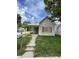 Modest home featuring a front porch, boarded windows and a small, grassy front yard at 1902 Orange St, Indianapolis, IN 46203