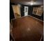 A look at a room with dark walls, light hardwood flooring, and a boarded window at 1902 Orange St, Indianapolis, IN 46203
