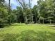 Scenic view of the private backyard with mature trees and lush green space at 1980 S Arthur Rd, Paragon, IN 46166
