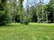 Scenic view of the private backyard with mature trees and lush green space at 1980 S Arthur Rd, Paragon, IN 46166