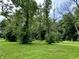 Spacious backyard with mature trees, perfect for outdoor activities at 1980 S Arthur Rd, Paragon, IN 46166