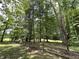 Scenic backyard featuring a rustic wooden fence and mature trees, creating a peaceful and natural setting at 1980 S Arthur Rd, Paragon, IN 46166