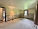 Spacious bedroom with two-tone walls, carpet, and a lamp at 1980 S Arthur Rd, Paragon, IN 46166