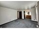 Bedroom featuring neutral carpet, a vanity area, and ample closet space with easy access to the bathroom at 1980 S Arthur Rd, Paragon, IN 46166