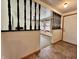 Welcoming entryway featuring a decorative railing, leading to a carpeted living room and a bright white front door at 1980 S Arthur Rd, Paragon, IN 46166