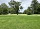Picturesque field with a weeping willow and storage shed, surrounded by lush greenery at 1980 S Arthur Rd, Paragon, IN 46166
