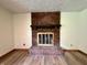 Elegant brick fireplace adding warmth and charm to the living space with wood-style flooring at 1980 S Arthur Rd, Paragon, IN 46166