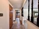 Inviting hallway with wood door and trim, leading into a well-lit kitchen and open living space at 1980 S Arthur Rd, Paragon, IN 46166