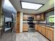 Functional kitchen featuring modern stainless steel appliances and wood cabinets at 1980 S Arthur Rd, Paragon, IN 46166