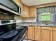 Kitchen with stainless steel appliances, wood cabinets, and modern fixtures at 1980 S Arthur Rd, Paragon, IN 46166