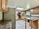 Well-lit kitchen with stainless steel appliances, wood cabinets, and updated countertops at 1980 S Arthur Rd, Paragon, IN 46166