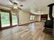 Open-concept living room with wood floors, a fireplace, and sliding glass doors at 1980 S Arthur Rd, Paragon, IN 46166