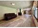 Open living space with wood floors, a wood burning stove, and a modern kitchen in the background at 1980 S Arthur Rd, Paragon, IN 46166