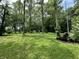 Expansive, well-maintained yard surrounded by lush trees, providing a serene and private outdoor space at 1980 S Arthur Rd, Paragon, IN 46166