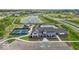 Aerial view of the community with a pool, clubhouse, playgrounds, pickleball court, and parking at 235 Highland Ave, Danville, IN 46122