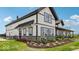Modern farmhouse exterior with white siding, black trim, and inviting landscaping at 235 Highland Ave, Danville, IN 46122
