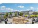 Community fire pit and seating area with lush landscaping near the pool house, a great place to spend the evenings at 235 Highland Ave, Danville, IN 46122