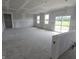 Large unfinished room with windows overlooking yard and slider at 235 Highland Ave, Danville, IN 46122
