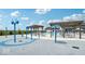 Community splashpad and pool area with umbrellas and covered seating at 235 Highland Ave, Danville, IN 46122