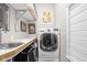 Functional laundry room with a washer, dryer, sink, and counter space at 25 E 40Th St # Apt 1B/D, Indianapolis, IN 46205