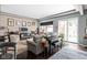 Inviting living room with piano, comfortable seating, and access to the outdoor patio at 25 E 40Th St # Apt 1B/D, Indianapolis, IN 46205