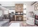 Cozy living room with stone accent wall, wet bar, and comfortable seating area at 25 E 40Th St # Apt 1B/D, Indianapolis, IN 46205