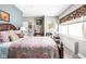 Relaxing bedroom featuring a paisley bedspread, side chair and large window at 25 E 40Th St # Apt 1B/D, Indianapolis, IN 46205