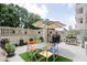 Inviting patio with colorful chairs, a table, and green turf at 25 E 40Th St # Apt 1B/D, Indianapolis, IN 46205