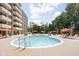 Outdoor pool area with lounge chairs and colorful umbrellas for a relaxing experience at 25 E 40Th St # Apt 1B/D, Indianapolis, IN 46205