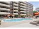 Outdoor pool area with lounge chairs and colorful umbrellas for a relaxing experience at 25 E 40Th St # Apt 1B/D, Indianapolis, IN 46205